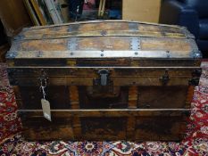 An antique iron bound dome top trunk, raised on castors, H.60 W.92 D.52cm