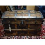 An antique iron bound dome top trunk, raised on castors, H.60 W.92 D.52cm