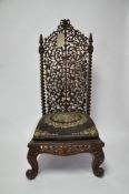An Indonesian carved teak high backed chair