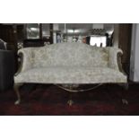 A 19th century George I style mahogany camel back sofa, with floral upholstery, raised on cabriole