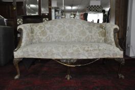 A 19th century George I style mahogany camel back sofa, with floral upholstery, raised on cabriole