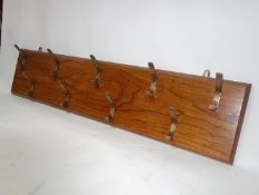 An oak wall hanging coat rack, H.25 W.114