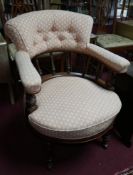 A Victorian aesthetic mahogany tub chair on castors