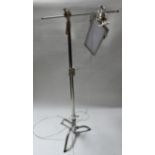 A chrome adjustable angle poise standard lamp