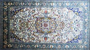 A Central Persian Qum rug, double pendent medallion with repeating stylised petal motifs on an ivory