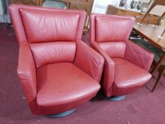 A pair of Kinnarps red leather swivel chairs