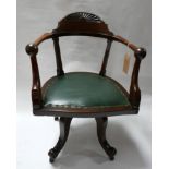 An Arts & Crafts oak swivel desk chair