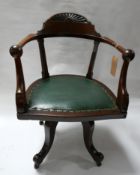 An Arts & Crafts oak swivel desk chair