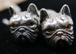 A pair of sterling silver cufflinks in the form of bulldog-heads with collars set with small