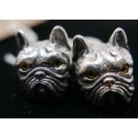 A pair of sterling silver cufflinks in the form of bulldog-heads with collars set with small