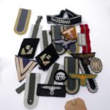 A collection of Third Reich and reproduction cloth badges and shoulder straps (qty)