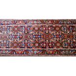 A North West Persian Farahan runner, repeating stylised petal motifs on a sapphire field