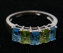 A 9ct white gold five stone ring, set with cushion cut aquamarine and green gemstones