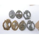 A collection of reproduction Third Reich badges, including two Infantry Assault badges etc.