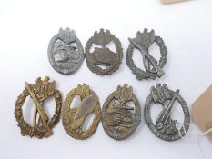 A collection of reproduction Third Reich badges, including two Infantry Assault badges etc.