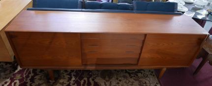 A mid 20th century Dyrlund Danish teak sideboard, with two sliding doors enclosing five central