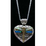 A sterling silver heart-shaped pierced pendant, adorned with a dragonfly inset with opalites on a