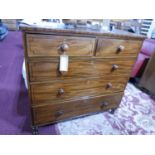 An early 19th century mahogany chest, two short over three long drawers, with ebony inlay, raised on