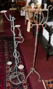 An iron candelabra, H.123cm together with one other