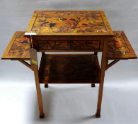 An Arts & Crafts walnut three tier side table, inlaid with images of parrots, signed with initials