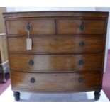 A Georgian mahogany bow front chest, two short over three long drawers, raised on turned legs, H.111