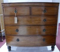 A Georgian mahogany bow front chest, two short over three long drawers, raised on turned legs, H.111