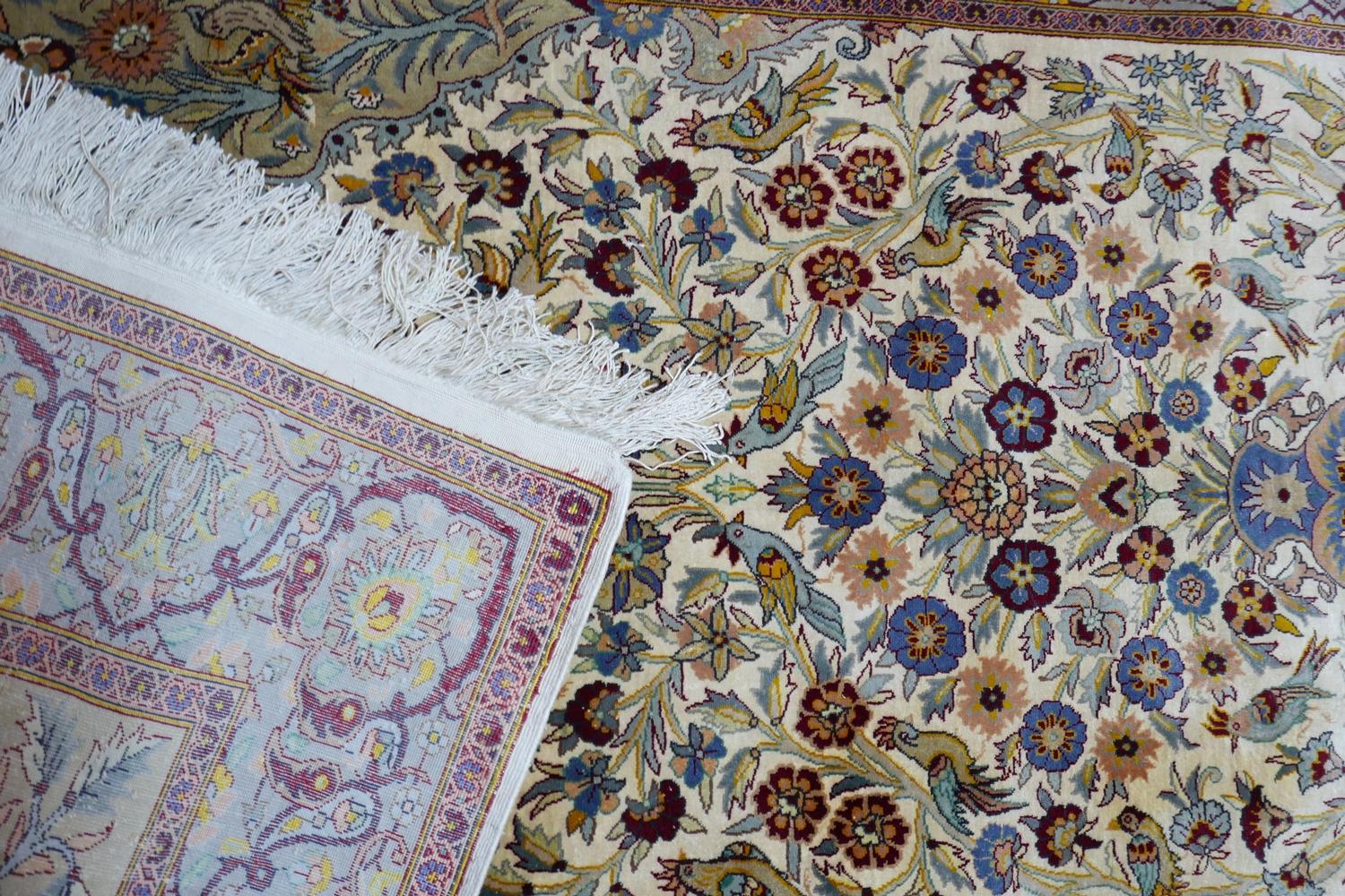 A 20th century fine silk Kashan rug, with zoomorphic and vase of flower design, contained by - Image 3 of 3