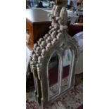 Three Gothic style garden mirrors, distressed painted, with floral finial above twin arched glass