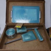 A vanity set, with faux enamel decoration, including a tray, mirror, dish and cover, and two brushes