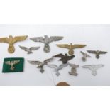A collection of reproduction Third Reich cap and uniform badges (12)