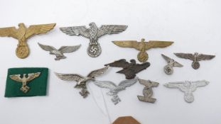 A collection of reproduction Third Reich cap and uniform badges (12)