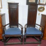 A pair of late 19th century oak high back gothic throne style armchairs, the toprails each carved