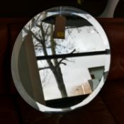 A large circular bevelled glass wall mirror, Diameter 60cm