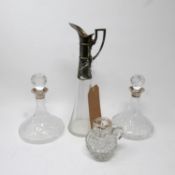 A pair of small crystal decanters with silver collars, together with a silver mounted jug and