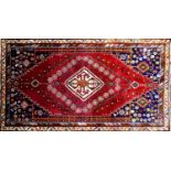 A South West Persian Qashgai carpet, central diamond medallion with repeating petal motifs on a