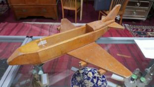A large ply wood model of a plane, stamped 'Community Robertsbridge Sussex', H.27 W.75 D.75cm