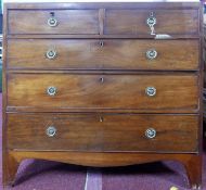 An early 19th century mahogany chest, two short over three long drawers, raised on shaped bracket