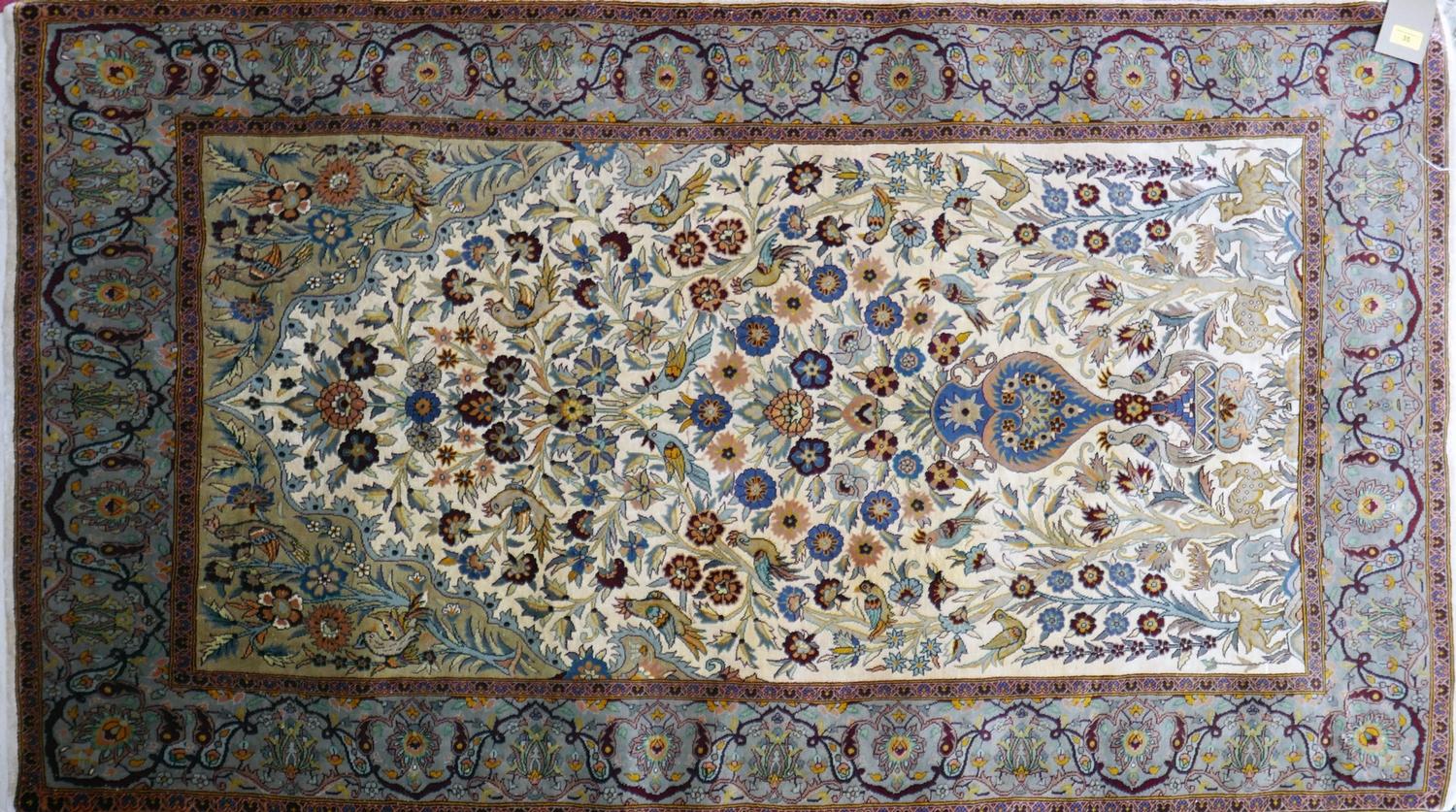 A 20th century fine silk Kashan rug, with zoomorphic and vase of flower design, contained by