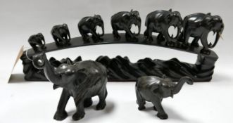 An early 20th century carved ebony group of elephant together with two others