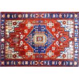 A North West Persian Nahawand rug, central diamond medallion with repeating geometric motifs on a