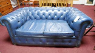 A blue leather Chesterfield sofa