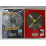 Two framed promotional Beatles records, Abbey road and Sgt Pepper