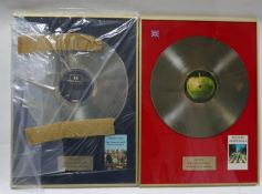 Two framed promotional Beatles records, Abbey road and Sgt Pepper