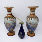 A pair of Doulton Lambeth vases, polychrome decorated with stylised flowers, on circular bases,