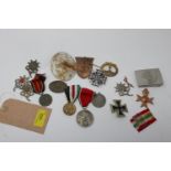 A collection of reproduction Third Reich badges, medals, and plaques