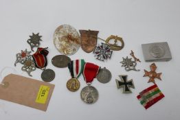 A collection of reproduction Third Reich badges, medals, and plaques