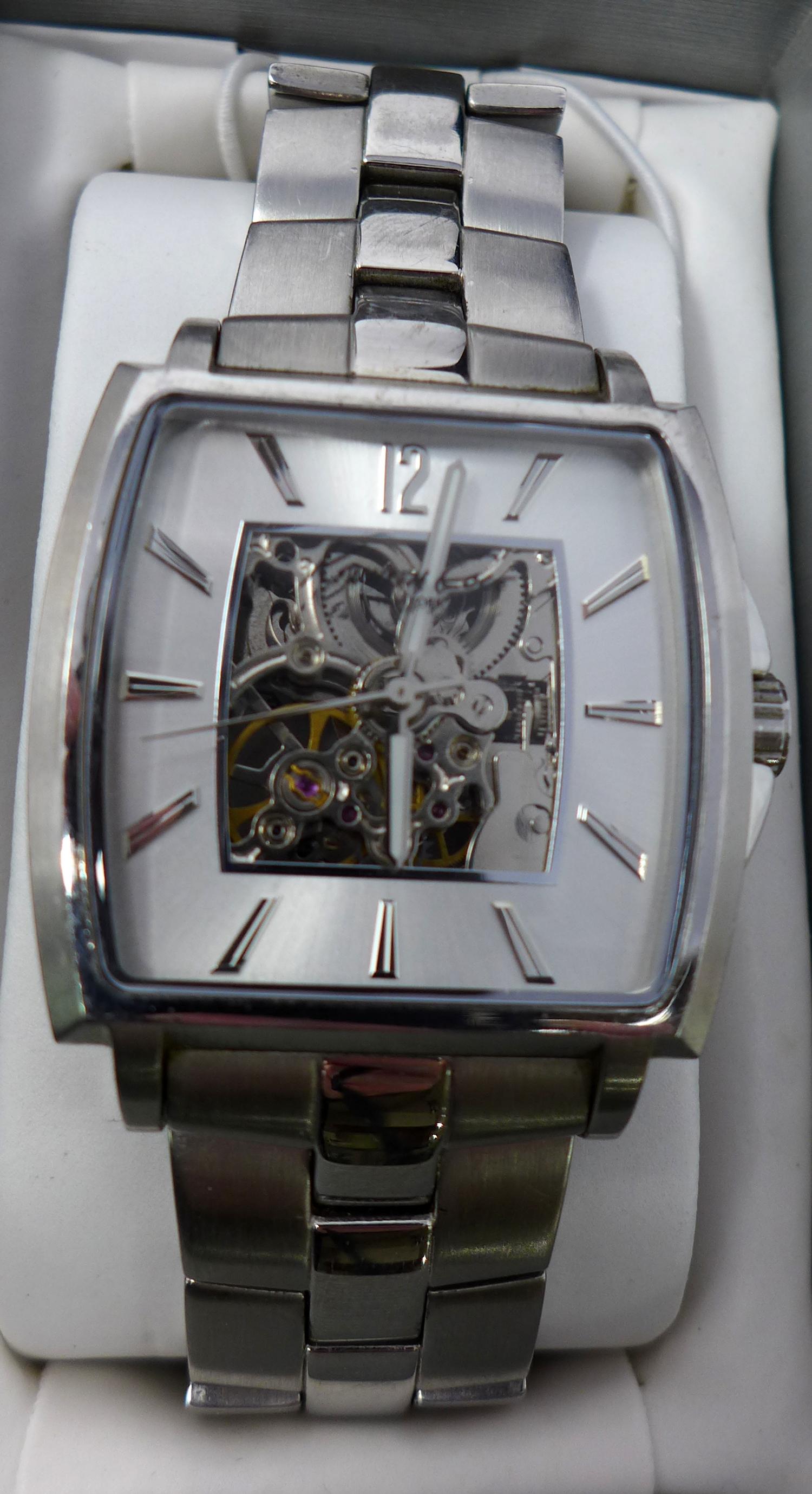 A Kenneth Cole gentleman's stainless steel wristwatch, skeleton dial with baton markers and Arabic