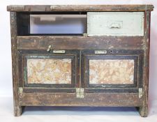 An early 20th century industrial work bench, with remnants of factory green paint and gilt gesso