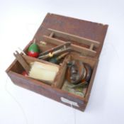 A collection of fishing tackle in a wooden box