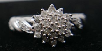 A 9ct white gold and diamond cluster ring of floral design, hallmarked